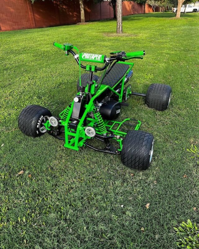 The limited edition Grinch Mini Quad by Shifted Standard displaying its custom green powder-coated frame, 212cc Ghost Motor, and dual stainless steel exhaust tips